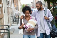 A couple holding their child 