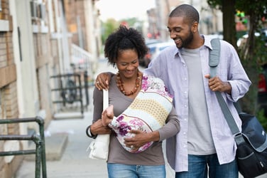 A couple holding their child 