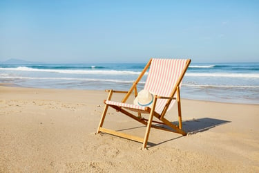 An empty chair on the beach, symbolizing relaxation and financial security through retirement plans for small businesses. Keywords: Retirement plan, SECURE 2.0 Act, employee benefits.