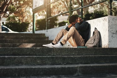 This photo depicts a student struggling with with mental health and the increasing struggles students face at universities.