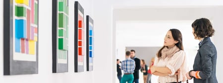 Two_women_viewing_artwork_in_gallery