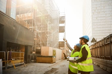 This photo shows two construction workers working on a construction site.