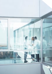 This photo shows a group of healthcare professionals talking in a hospital.