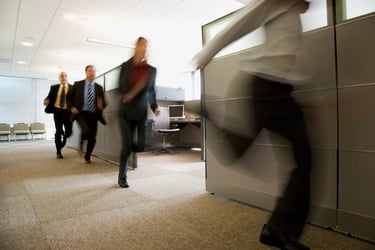 Employees evacuating their office building due to a crisis.  