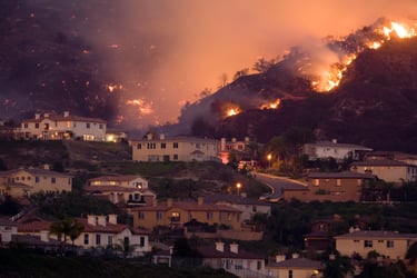 The photo shows a wildfire breaking out in California depicting California's 2024 Insurance Reforms, emphasizing high wildfire risk areas, premium trends, and regulatory changes.