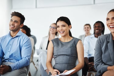 This photo shows eight young professionals seated in three rows watching a presentation. You can’t see the presenter, but the interns are smiling. In addition to formal instruction, gold standard internships also include purposeful work, mentorship, networking opportunities, and leadership feedback.