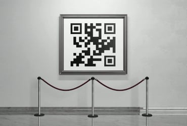 a framed QR barcode hanging in a gallery setting