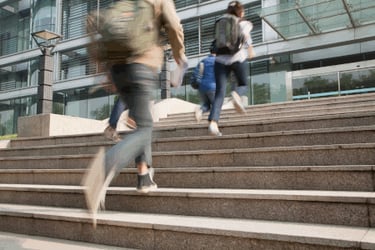 students walking up stairs into a building