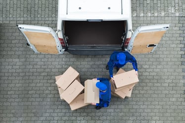 workers unloading boxes from a van