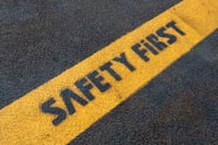 a stenciled sign that reads SAFETY FIRST