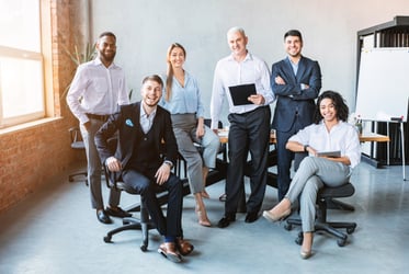 A diverse group of insurance professionals sitting in an office space.