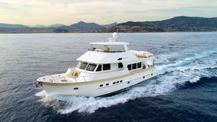  Gleaming yacht against a coastal backdrop, its journey as serene as the security that comprehensive boat and yacht insurance policies offer, safeguarding against the unpredictable.