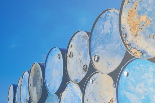 Rusty metal barrels stacked in rows