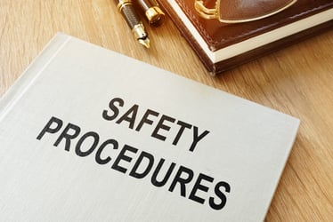 This image shows a Safety Procedures booklet on a desk