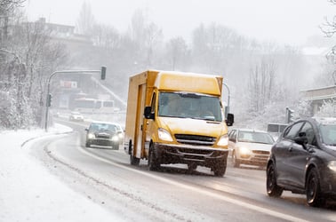 This photo shows snow-covered cards in a winter landscape, highlighting the importance of winter preparedness and safety measures for vehicle owners. 