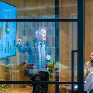man-giving-a-big-data-presentation-on-a-tv-in-a-board-room-800x800